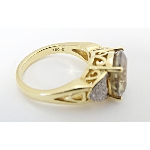 586 - An 18ct gold ring set with central Csarite flanked by diamonds. Ring size approx. N