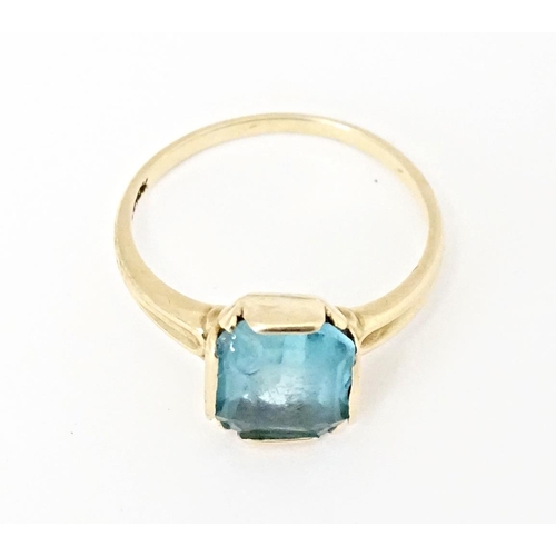 598 - A Continental Art Deco style 10k gold ring set with central blue stone. Ring size approx. N 1/2