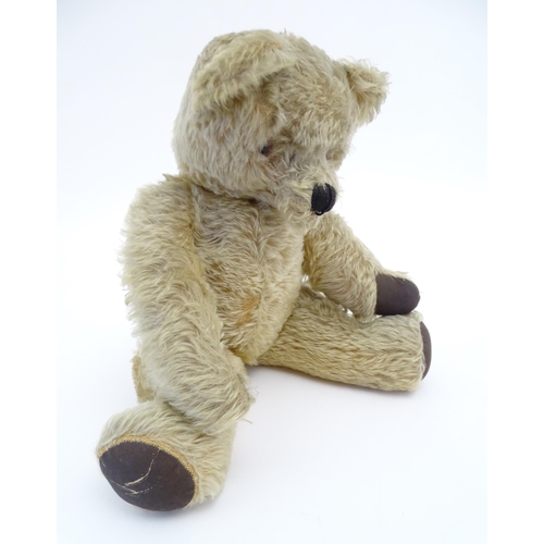 824 - A 20thC mohair teddy bear with moving mouth mechanism, stitched nose, pad paws and articulated limbs... 