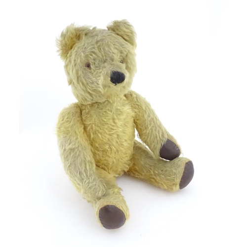 825 - Toy: A 20thC mohair teddy bear with stitched nose and mouth, pad paws and articulated limbs, a clock... 