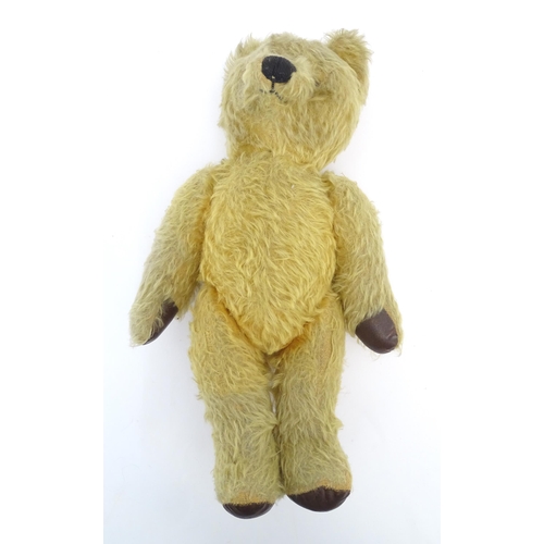 825 - Toy: A 20thC mohair teddy bear with stitched nose and mouth, pad paws and articulated limbs, a clock... 