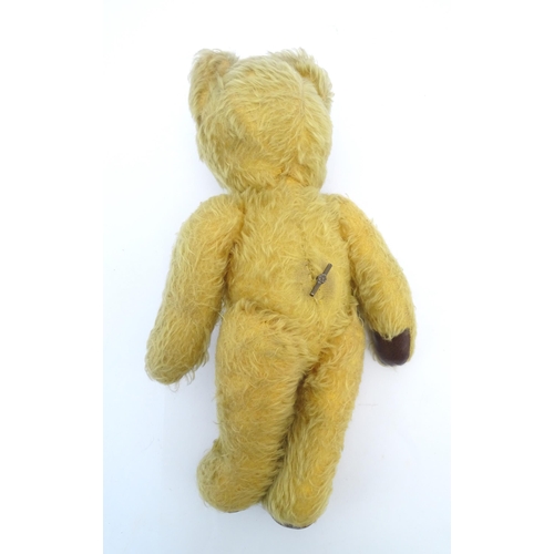 825 - Toy: A 20thC mohair teddy bear with stitched nose and mouth, pad paws and articulated limbs, a clock... 