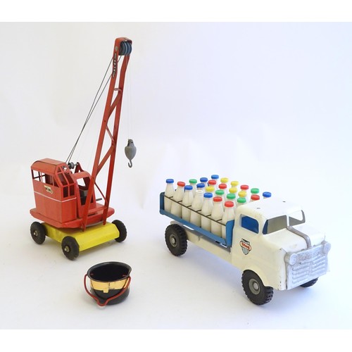 832 - Toys: A tinplate Triang Hi-way Milk Float / truck with milk bottles, boxed. Together with a Tri-ang ... 