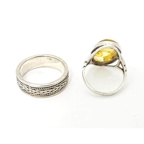 625 - Four various silver and white metal dress rings, some set with amber (4)