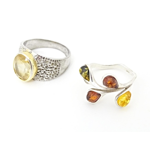 625 - Four various silver and white metal dress rings, some set with amber (4)