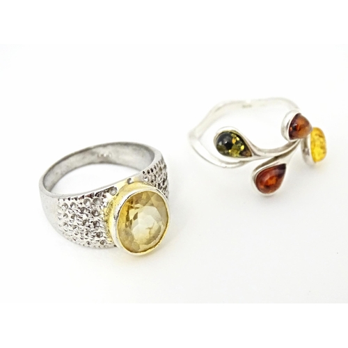 625 - Four various silver and white metal dress rings, some set with amber (4)