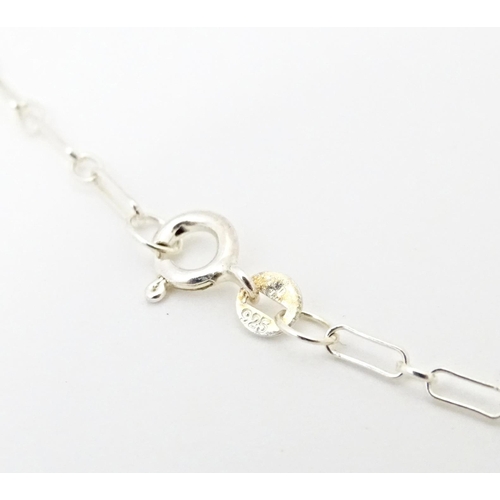 667 - A silver pendant and chain, the pendant inspired by the designs of Mackintosh. The chain 18