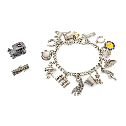 675 - A silver and white metal charm bracelet with various charms including a 9ct gold charm formed as a s... 