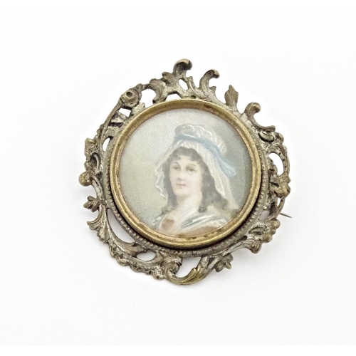 676 - A late 19thC / early 20thC brooch set with watercolour portrait to centre depicting a lady wearing a... 