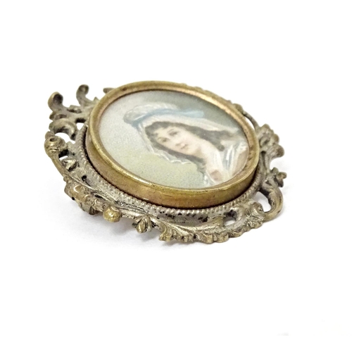 676 - A late 19thC / early 20thC brooch set with watercolour portrait to centre depicting a lady wearing a... 