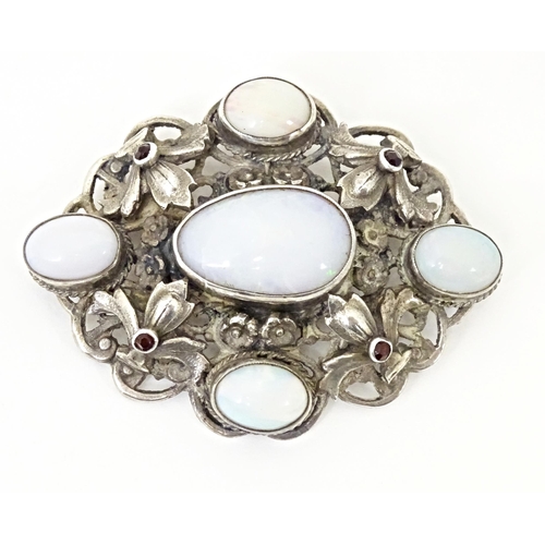 678 - A Zoltan White & Co silver Arts & Crafts Austro-Hungarian influenced brooch , set with garnets and o... 