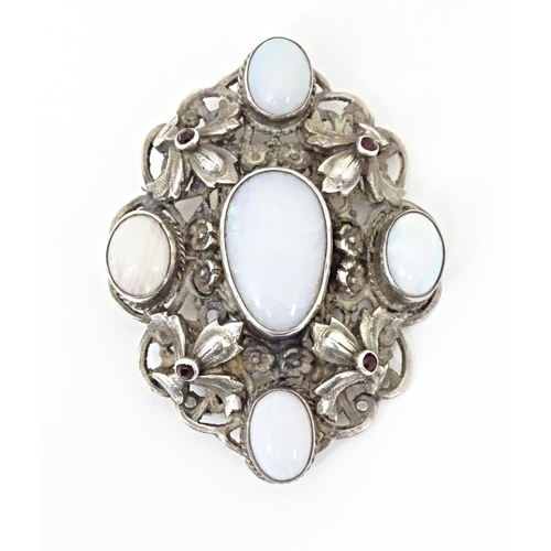 678 - A Zoltan White & Co silver Arts & Crafts Austro-Hungarian influenced brooch , set with garnets and o... 