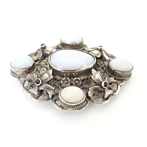 678 - A Zoltan White & Co silver Arts & Crafts Austro-Hungarian influenced brooch , set with garnets and o... 