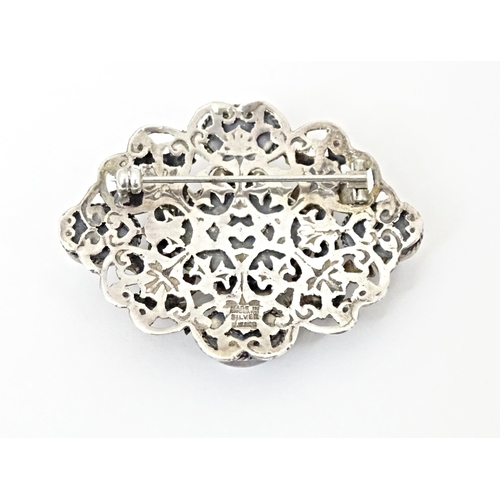 678 - A Zoltan White & Co silver Arts & Crafts Austro-Hungarian influenced brooch , set with garnets and o... 