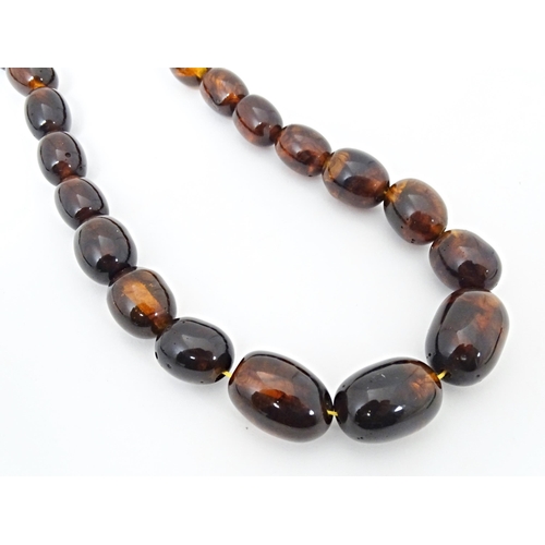 684 - A bead necklace of amber coloured graduated beads approx  24