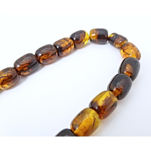 684 - A bead necklace of amber coloured graduated beads approx  24