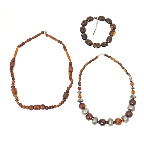 685 - Three assorted bead necklaces with amber coloured beads. Longest approx 30