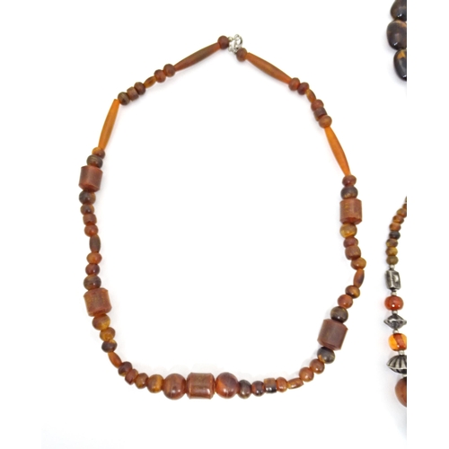 685 - Three assorted bead necklaces with amber coloured beads. Longest approx 30