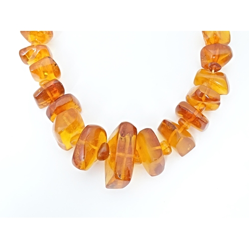 686 - A vintage necklace of graduated amber coloured beads. Approx 18