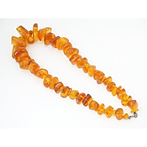 686 - A vintage necklace of graduated amber coloured beads. Approx 18