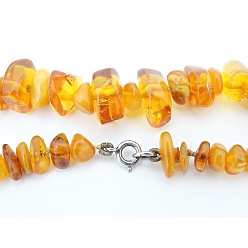 686 - A vintage necklace of graduated amber coloured beads. Approx 18