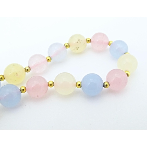 689 - A bead necklace of pink, blue and cream, coloured tourmaline beads. Approx 18