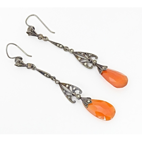 674 - A pair of white metal drop earrings set with marcasite and carnelian coloured facet cut drops. Appro... 