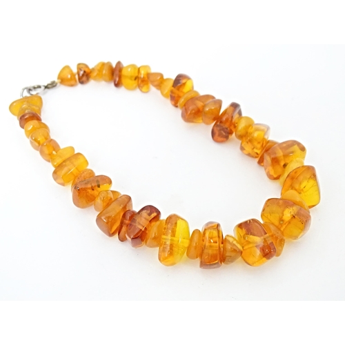 686 - A vintage necklace of graduated amber coloured beads. Approx 18