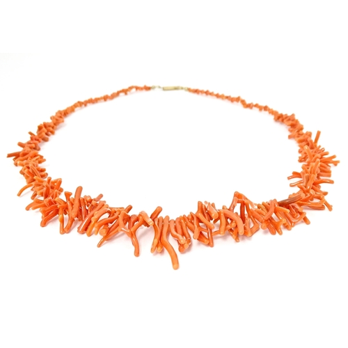 692 - A coral necklace of graduated coral branch beads. Approx  22