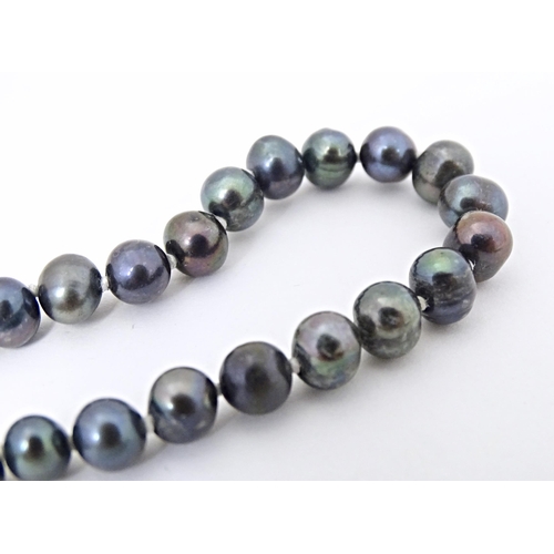 693 - A  black pearl necklace approx 22