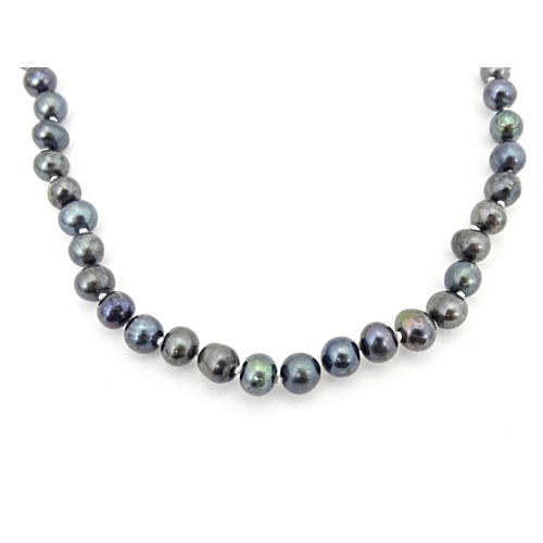 693 - A  black pearl necklace approx 22