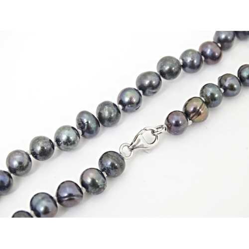 693 - A  black pearl necklace approx 22