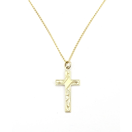 696 - A 9ct gold pendant of cross form 1