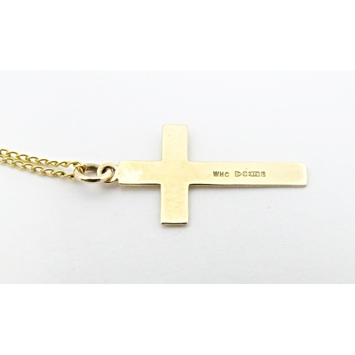 696 - A 9ct gold pendant of cross form 1