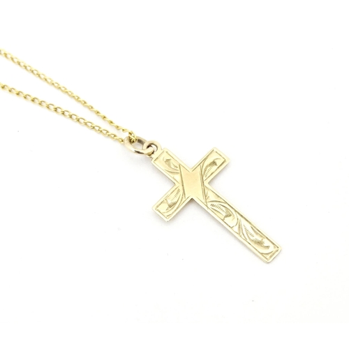 696 - A 9ct gold pendant of cross form 1