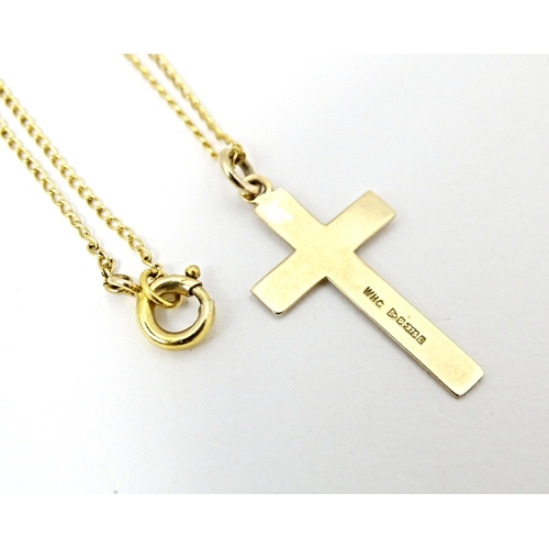 696 - A 9ct gold pendant of cross form 1