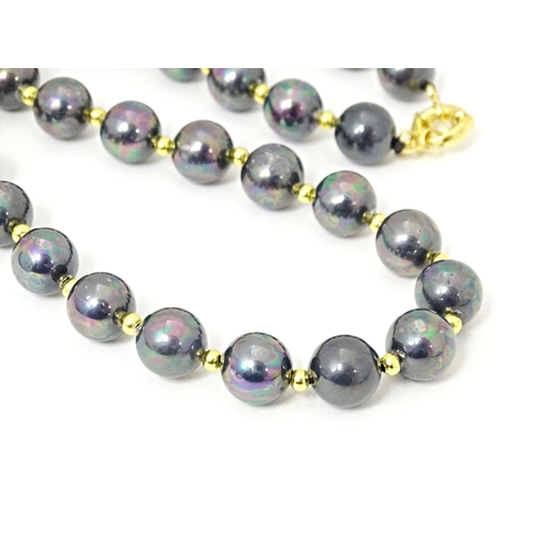 697 - A gilt metal and black pearl bead necklace approx 18