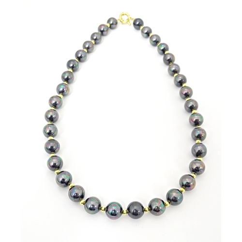 697 - A gilt metal and black pearl bead necklace approx 18