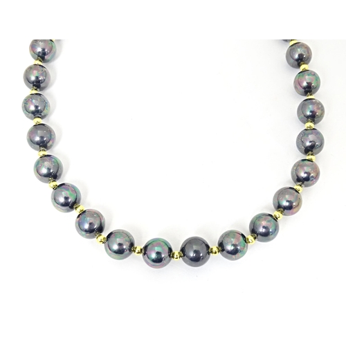 697 - A gilt metal and black pearl bead necklace approx 18