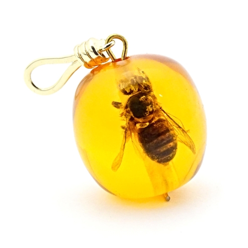 701 - A amber coloured copal style bead having insect within. 1