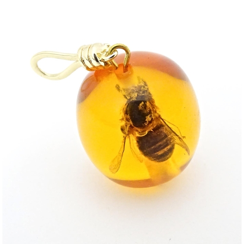 701 - A amber coloured copal style bead having insect within. 1