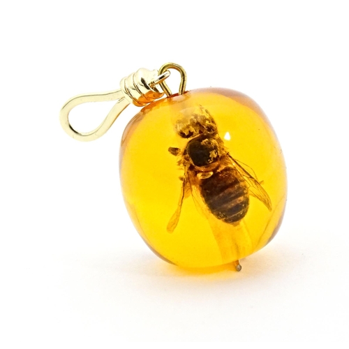 701 - A amber coloured copal style bead having insect within. 1