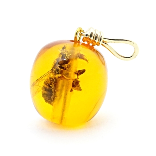 701 - A amber coloured copal style bead having insect within. 1