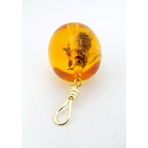 701 - A amber coloured copal style bead having insect within. 1