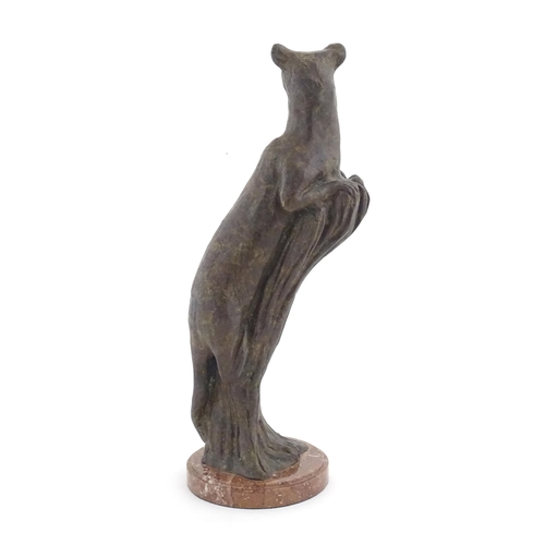 978 - A 20thC Continental cast patinated bronze model of a leopard / big cat on a styled tree stump. On a ... 