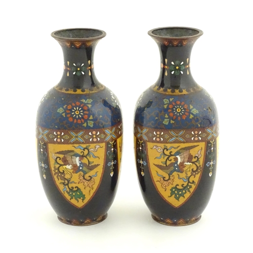 980 - A pair of Oriental cloisonne vases decorated with panels of dragons and phoenix birds, the shoulders... 