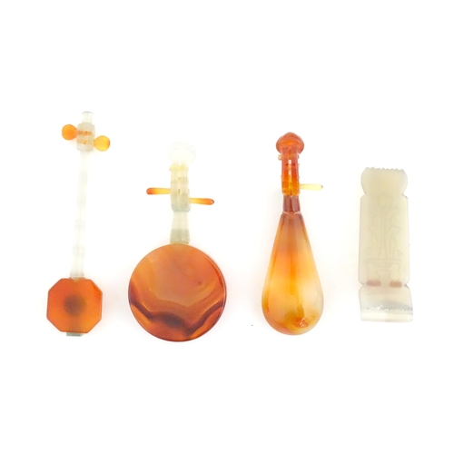 989 - Four Oriental agate models of musical instruments to include lute, quqin, etc. with wooden stands. L... 