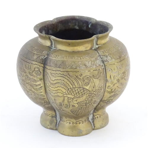 990 - A Chinese brass lobed pot decorated with dragons, phoenix birds and pagoda buildings. Character mark... 