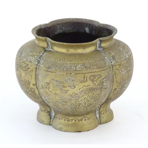 990 - A Chinese brass lobed pot decorated with dragons, phoenix birds and pagoda buildings. Character mark... 