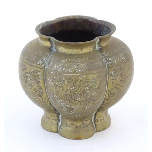 990 - A Chinese brass lobed pot decorated with dragons, phoenix birds and pagoda buildings. Character mark... 